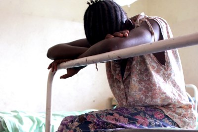 A young girl waits for treatment.