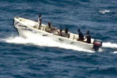 Pirates transiting from MV Faina to shore while under observation by a U.S. Navy ship.