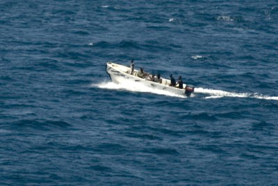 Pirates transiting from MV Faina to shore while under observation by a U.S. Navy ship. (File Photo)