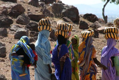 Women returning from the market (file photo).