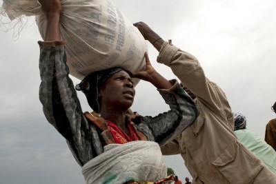 DR Congo: A woman carries a bag of food ration.