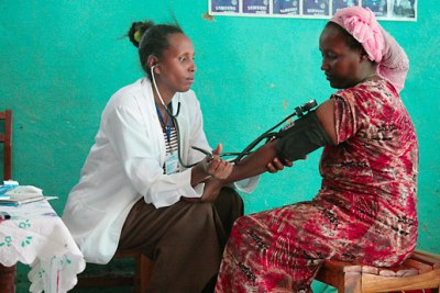 Health Worker reaching out to female at the community level (file photo).