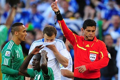 Sani Kaita of Nigeria gets a red card after fouling Vasileios Torosidis of Greece.