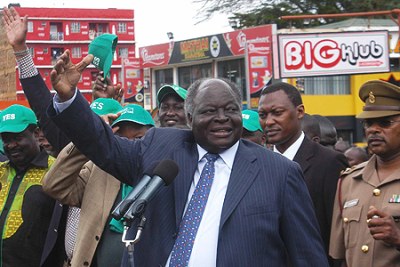 President Kibaki waves to a crowd at Karatina town.