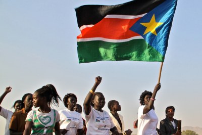 Women carrying the South Sudanese flag.