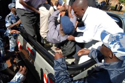 Opposition Leader Kizza Besigye being manhandled at Kasangati Police Station weeks before his arrest.