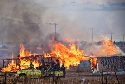 Homes burning in Abyei town during May (file photo).