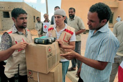 Washka, 100 km west of Sirte, Libya. Libyan Red Crescent volunteers prepare supplies for distribution.