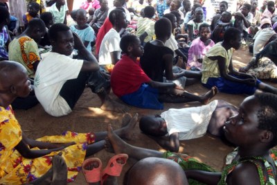 Children affected by nodding disease wait at a treatment centre in Kitgum.