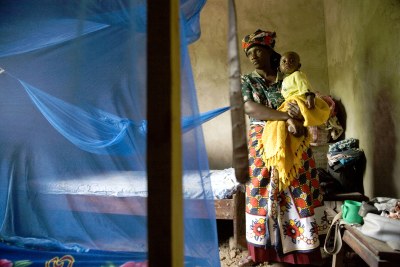 Saumo Mpotwile and her daughter, Anali,  with their bed net at the family's home in Lupiro village, Tanzania.