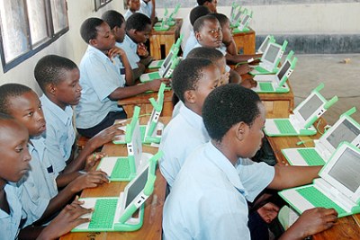 Primary school children using laptops. Over 200,000 units will have been distributed by the end of the year.
