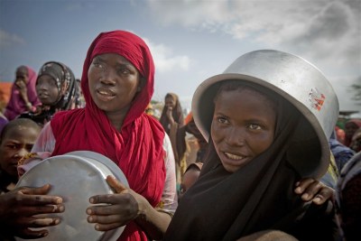Families queue for food in Badbado IDP camp, Mogadishu (file photo)