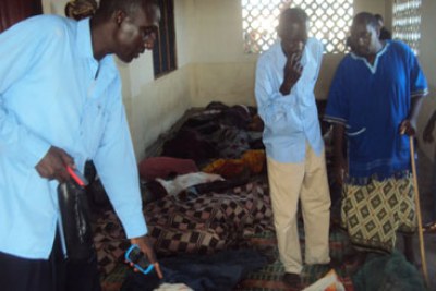 Residents view victims of ethnic violence at a mosque in the Tana Delta District (file photo).