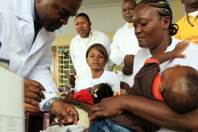 A young child is immunised with the new Pneumonia vaccine in Kinshasa, Congo.