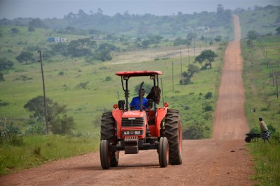 A tractor driving through farmlands.