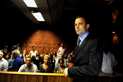 Paralympian Oscar Pistorius enters the dock at the Pretoria Magistrate's Court.