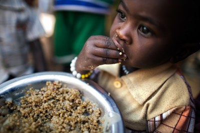 A child has a meal at a food distribution centre in the Rwanda camp for internally displaced persons (IDPs), near Tawila, North Darfur. More than 8,000 women and children living in the camp benefit from nutrition programmes run by the World Food Programme (WFP).