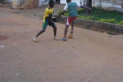 Kids from a poor neighbourhood in Yaounde, Cameroon’s capital, kick around a football.
