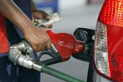 A man fills in a car at a fuel station (file photo).