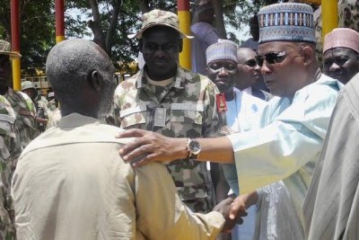 Military handing over rescued victims to Borno state governor, Kashim Shettima.