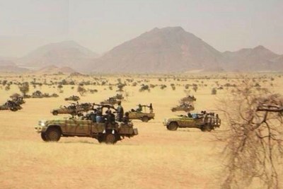 Troops drive in armoured vehicles in East Jebel Marra.