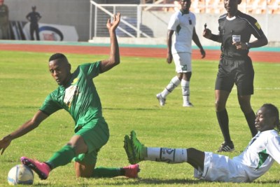 Young Africans defender, Kelvin Yondani (left), battles for the ball with Antonio Kasule of Angola’s Sagrada Esperanca.