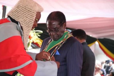 Former Chief Justice Godfrey Chidyausiku and President Robert Mugabe (file photo).