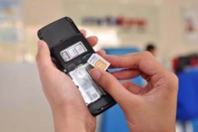 A person putting a SIM card in a mobile phone (file photo).