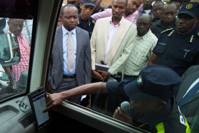 A traffic officer shows government officials how speed governors will work in public vehicles.