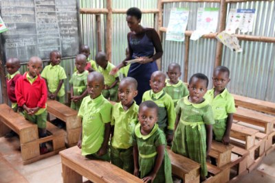 Bridge International Academies Kasokoso teacher Miriam Nambya attends to nursery kids in class November 7.