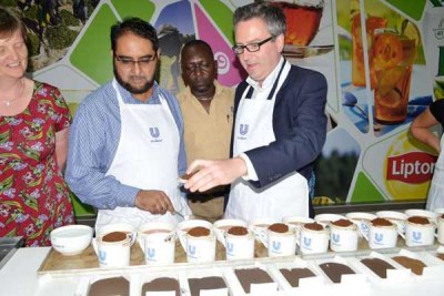 British High Commissioner to Kenya Nic Hailey (right) and Niaz Tarmahomed (centre), the procurement manager at Unilever Kenya, taste tea at the company’s offices in Mombasa.