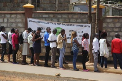 People queue to register as voters (file photo).