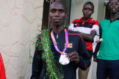 Joshua Cheptegei shows off his IAAF World Athletics Championships silver medal in Kampala.