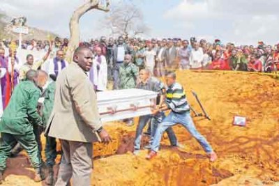 Anglican Church of Tanzania Archbishop Dr Jacob Chimeledya, left, at the burial of six people who were killed in a road accident in Uganda last weekend as they were returning home to Tanzania from wedding ceremony in Kampala.