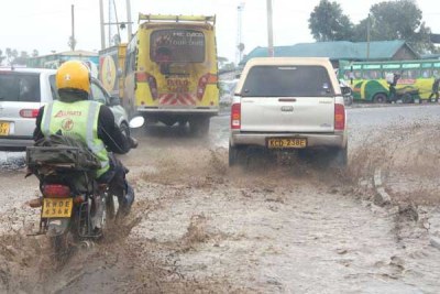 Motorists driving through a flooded road at the City Stadium roundabout in Nairobi as heavy rains continue to pound the city in this picture taken on November 14, 2017.