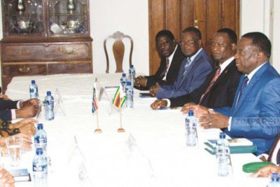 President Emmerson Mnangagwa, flanked by Zimbabwe’s Ambassador to South Africa Cde Isaac Moyo (third from left), Foreign Affairs and International Trade Minister Retired Lieutenant-General Sibusiso Busi Moyo (right), Transport and Infrastructural Development Minister Joram Gumbo (second from left), and Industry, Commerce and Enterprise Development Minister Mike Bimha, meets his South African counterpart President Jacob Zuma and government officials at the Zimbabwe Embassy in Pretoria, South Africa, yesterday.