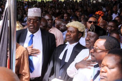 Nasa leader Raila Odinga, flanked by lawyers Miguna Miguna, TJ Kajwang and James Orengo during the swearing in ceremony at Uhuru Park.