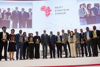 Presidents Paul Kagame of Rwanda and Macky Sall of Senegal (centre) pose for a group photo with 17 African scientists who were recognised for their outstanding contribution towards advancing science on the continent.