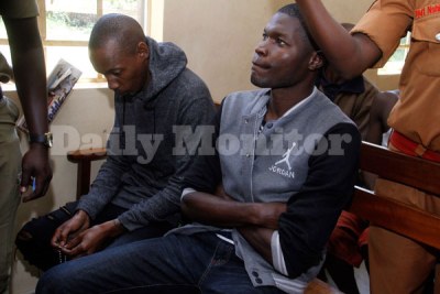 Socialite Brian Kirumira popularly known as Bryan White, left, and his bodyguard Corporal Thomas Okot at Makindye Magistrate's Court on December 21, 2017.