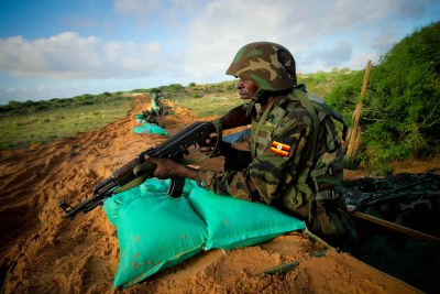 A Ugandan soldier service with the African Union Mission in Somalia stands on guard on the northern city limit of Mogadishu, Somalia.