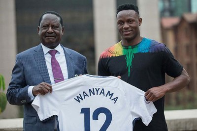 Arsenal die-hard fan Raila Odinga accepting a Tottenham jersey.