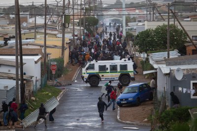 Protesters run from a Nyala in Mandela Street, Zwelihle, Hermanus (file photo).