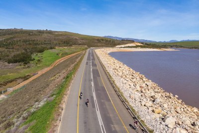Cyclists ride past Theewaterskloof Dam, which has seen improved water levels after a prolonged drought.