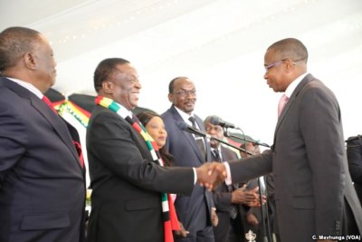 President Emmerson Mnangagwa congratulates the new Finance and Economic Development Minister Mthuli Ncube while flanked by Vice Presidents Constantino Chiwenga (left) and Kembo Mohadi at State House (file photo).