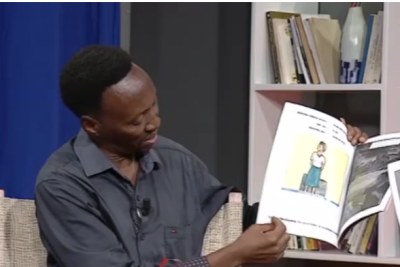 Patrick Gihana with his book Humura Mwana.