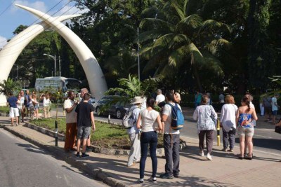 A group of tourists take photos at the iconic Tusks along Moi Avenue in Mombasa's CBD.