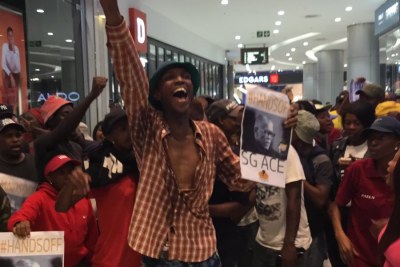 Protesters at the Sandton launch of Pieter-Louis Myburgh's book Gangster State: unravelling Ace Magashule’s Web of Capture.