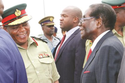 The late former president Robert Mugabe talks to then Zimbabwe Defence Forces Commander General Constantino Chiwenga (file photo).