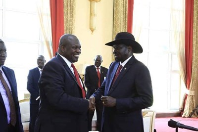 South Sudan President Salva Kiir, right, shakes hands with opposition leader Riek Machar during a meeting at State House Entebbe, Uganda on November 7, 2019.