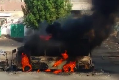 A bus burns following violence in Port Sudan